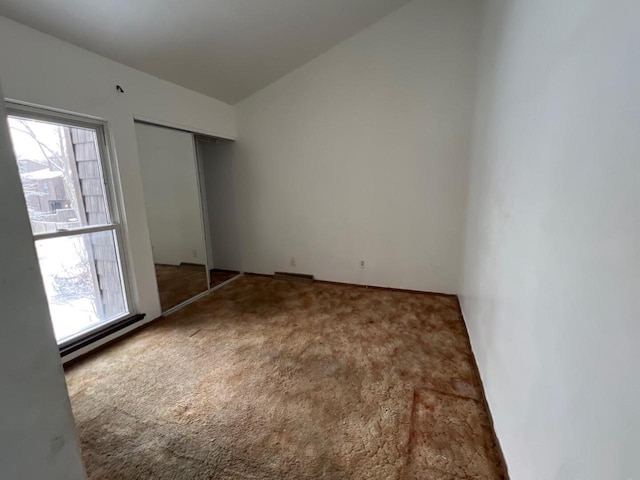 carpeted empty room featuring a wealth of natural light