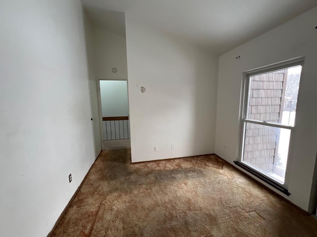 carpeted spare room featuring plenty of natural light