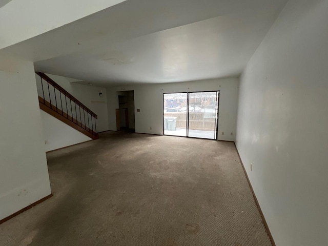 unfurnished living room featuring carpet floors