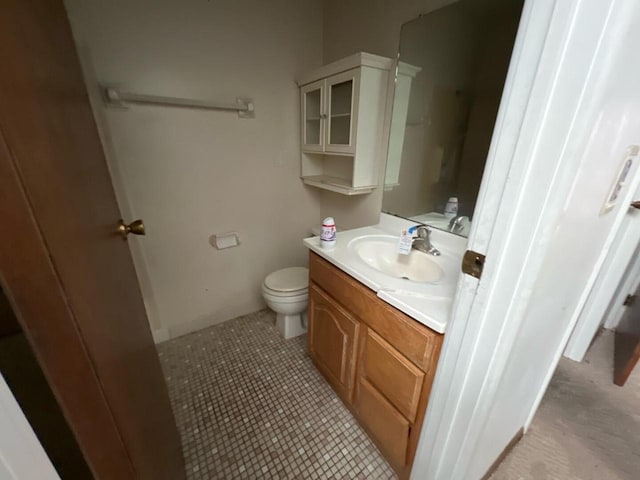 bathroom featuring tile patterned flooring, vanity, and toilet