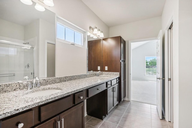 bathroom with an enclosed shower, vanity, and tile patterned floors