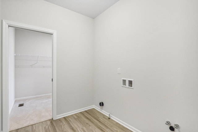 clothes washing area featuring gas dryer hookup, washer hookup, and light hardwood / wood-style flooring