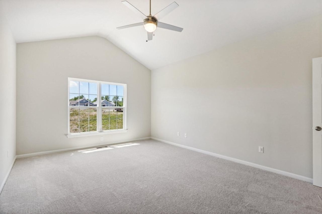 carpeted empty room with ceiling fan and vaulted ceiling