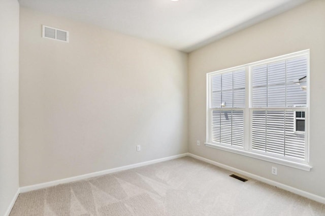 spare room with light colored carpet