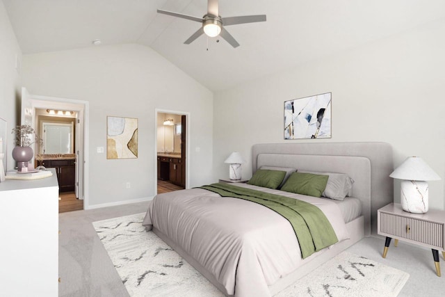 carpeted bedroom featuring connected bathroom, vaulted ceiling, and ceiling fan