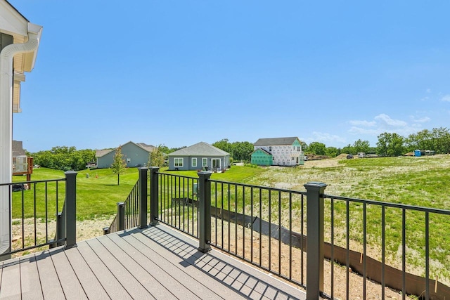 wooden terrace featuring a lawn