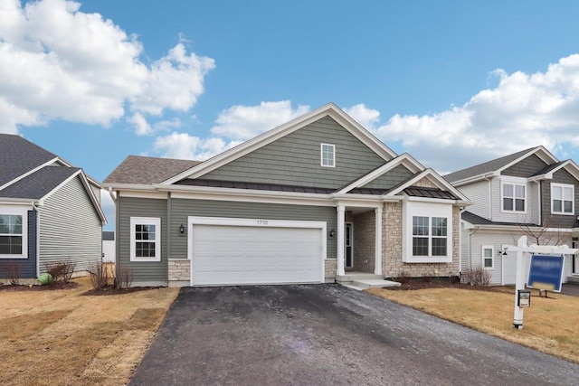 view of front of property featuring a garage and a front yard