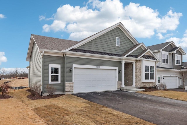 craftsman-style home featuring a garage and a front yard