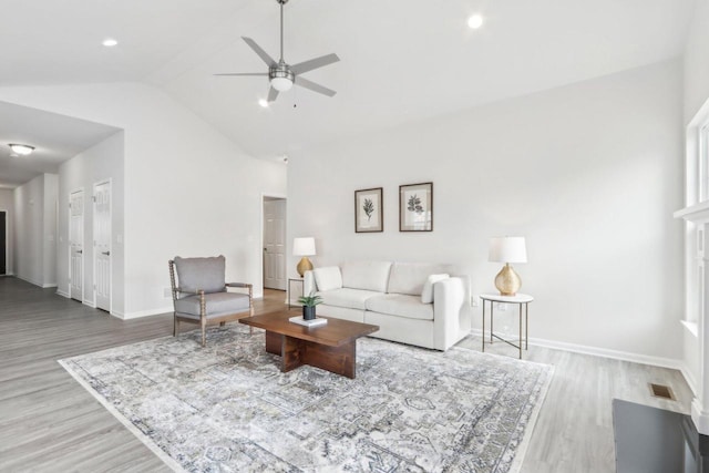 living room featuring ceiling fan, lofted ceiling, and hardwood / wood-style floors