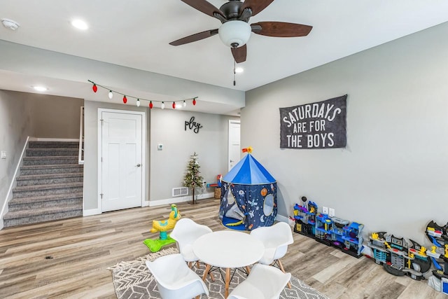 game room featuring wood-type flooring and ceiling fan