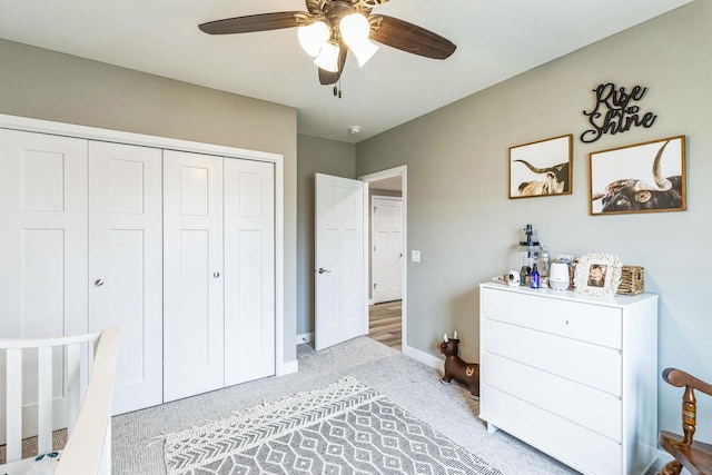 bedroom with ceiling fan, a closet, and light carpet