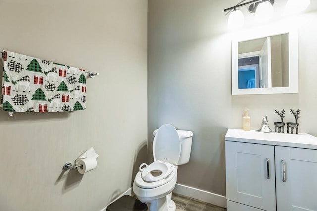 bathroom featuring hardwood / wood-style floors, vanity, and toilet