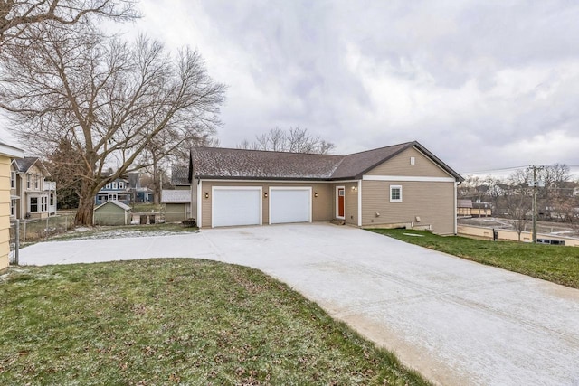 view of front facade with a garage and a front lawn