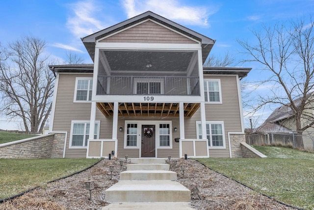 view of front of house featuring a front yard and a sunroom