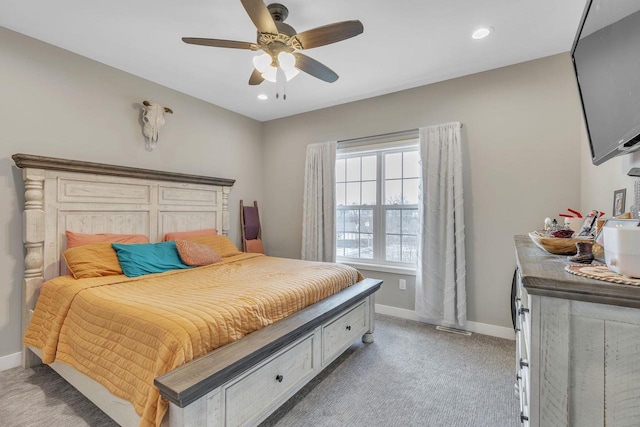 bedroom with ceiling fan and light carpet