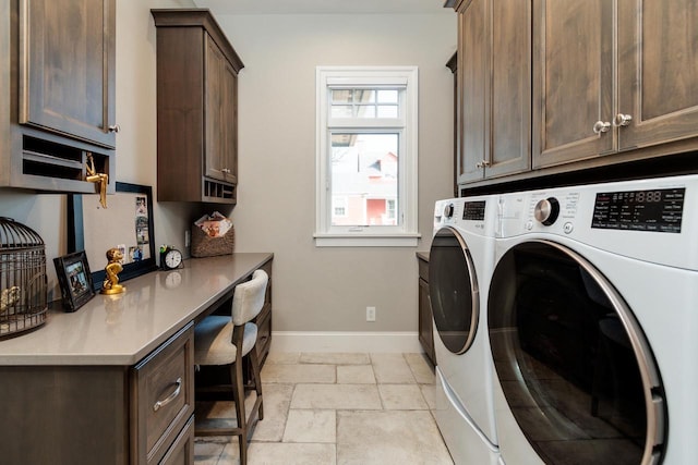 laundry area with washer and clothes dryer and cabinets