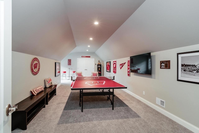 recreation room featuring carpet floors and vaulted ceiling