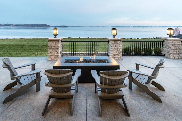 view of patio / terrace featuring a fire pit and a water view