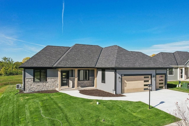 view of front of property featuring a garage, a front yard, and cooling unit