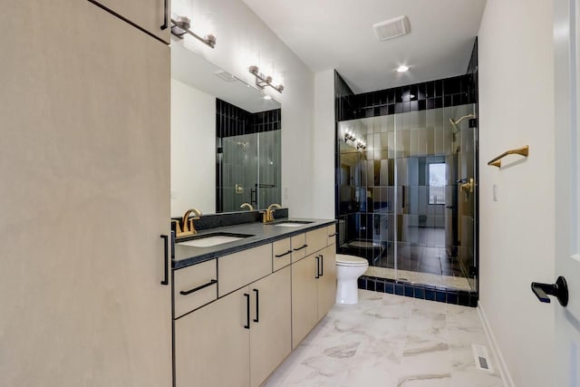 bathroom with vanity, toilet, and an enclosed shower