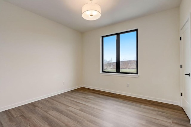 spare room featuring light hardwood / wood-style flooring