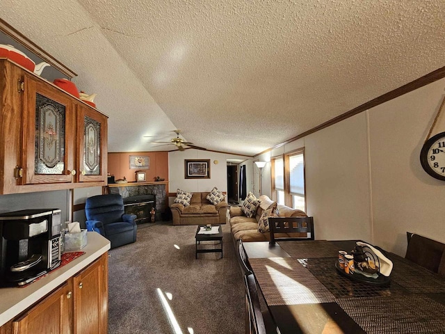 carpeted dining area with a textured ceiling, crown molding, ceiling fan, and lofted ceiling