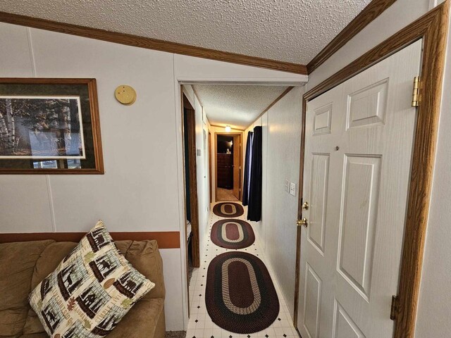 laundry area featuring crown molding and a textured ceiling