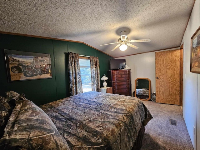 bedroom featuring ceiling fan, carpet floors, a textured ceiling, and lofted ceiling