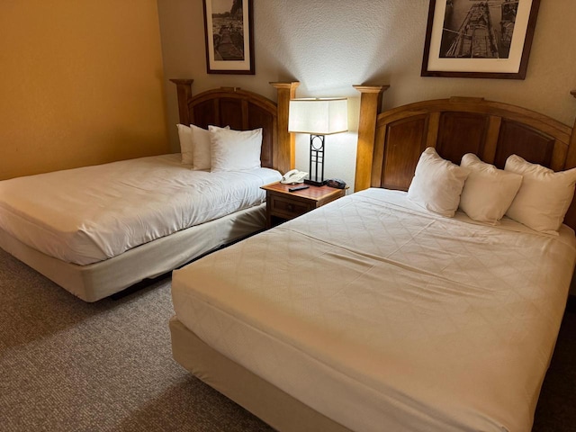 bedroom with carpet flooring and a textured ceiling