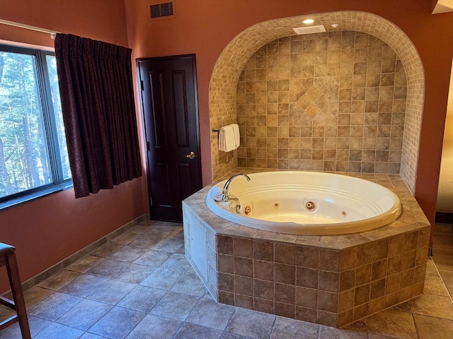 bathroom featuring a relaxing tiled tub