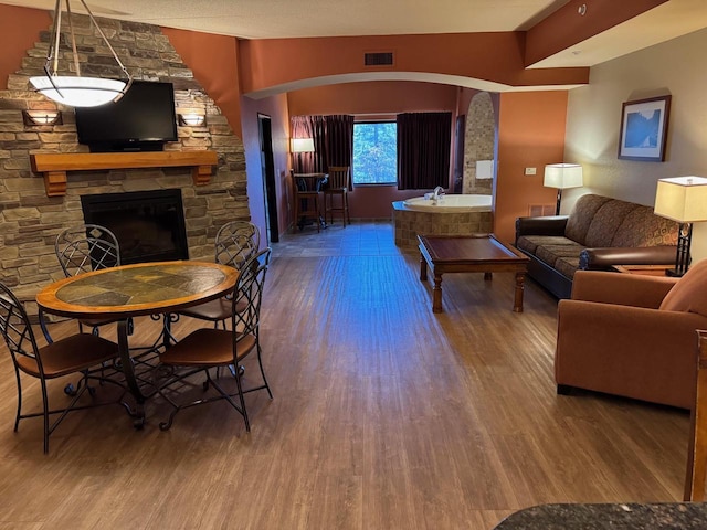 living room with a fireplace and hardwood / wood-style floors