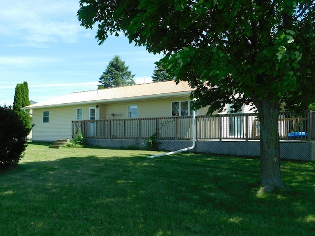 back of house featuring a deck and a yard