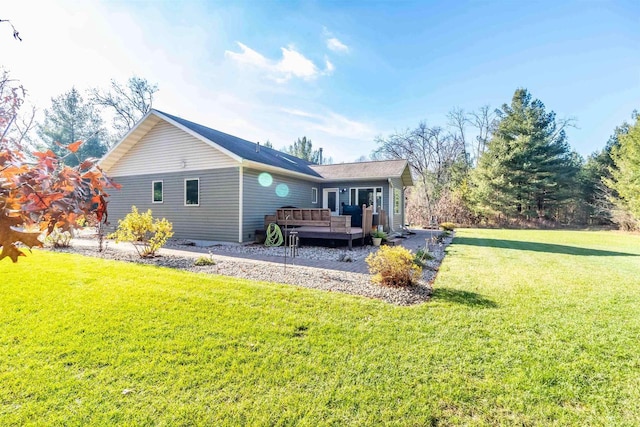 back of property featuring a yard and a wooden deck