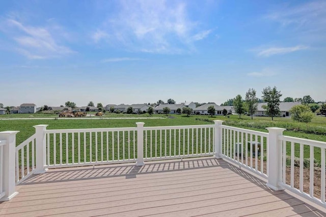 wooden terrace featuring a lawn