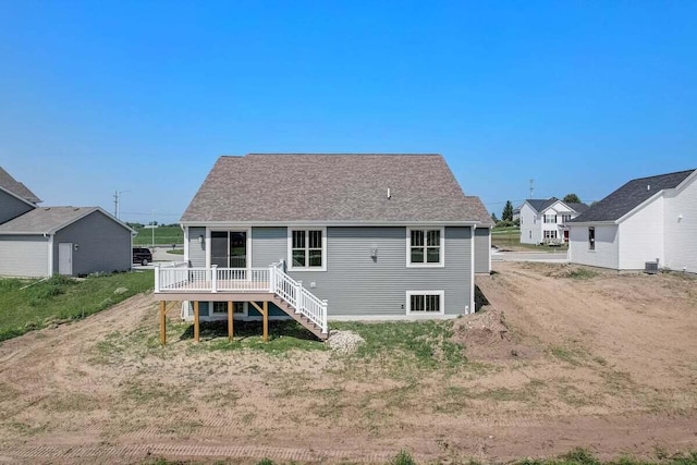 rear view of property with central AC