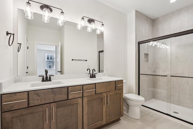 bathroom with vanity, toilet, and a shower with shower door