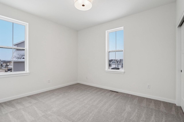 carpeted empty room featuring a healthy amount of sunlight