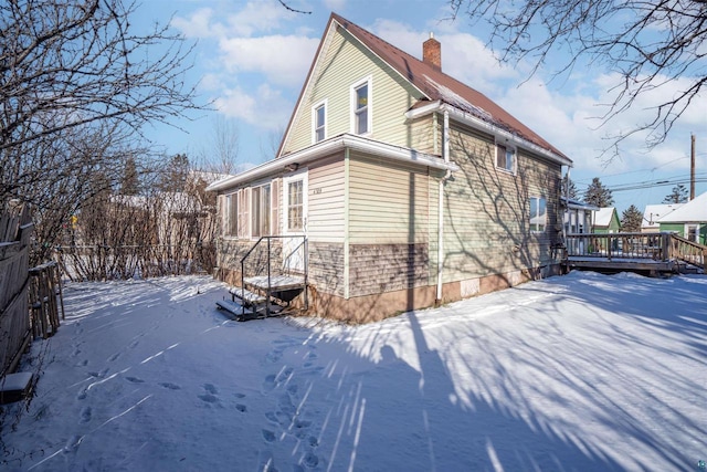 view of snow covered exterior featuring a deck