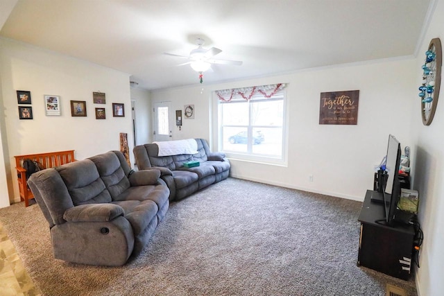 carpeted living room with ceiling fan and ornamental molding