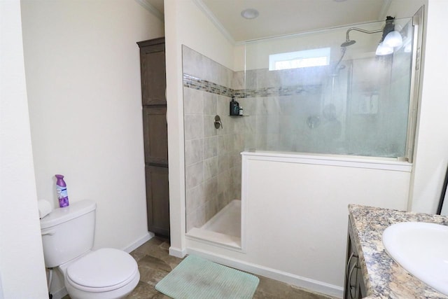 bathroom with vanity, toilet, a shower, and crown molding