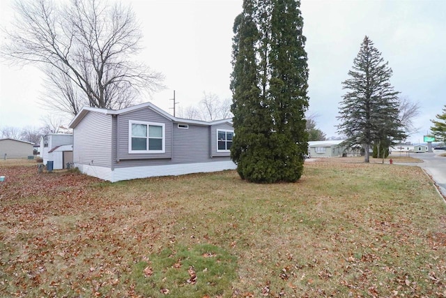 view of property exterior featuring a lawn