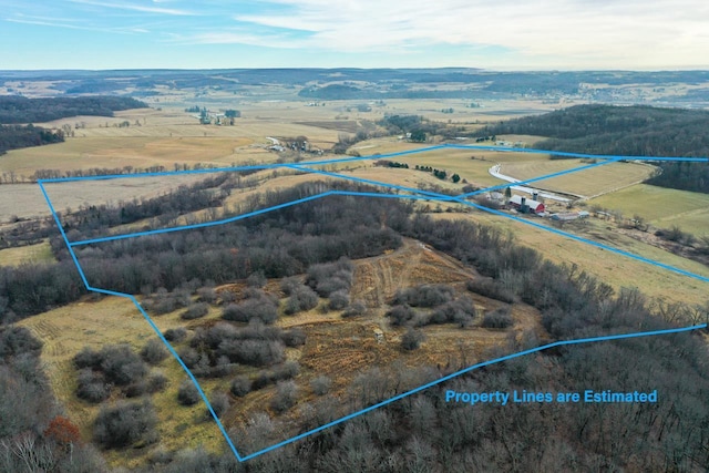 birds eye view of property with a rural view