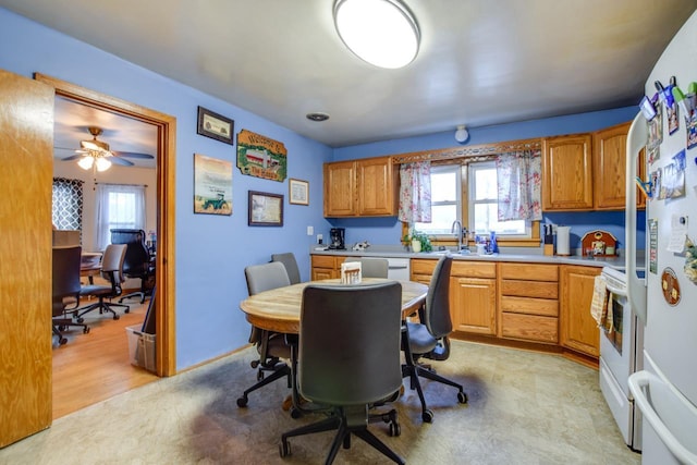 kitchen with ceiling fan, white refrigerator, range, and sink