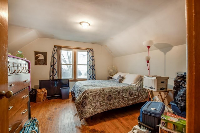 bedroom featuring hardwood / wood-style flooring and lofted ceiling