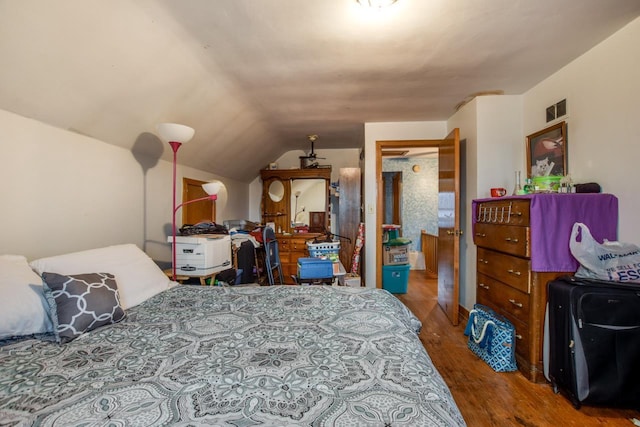 bedroom featuring wood-type flooring and lofted ceiling