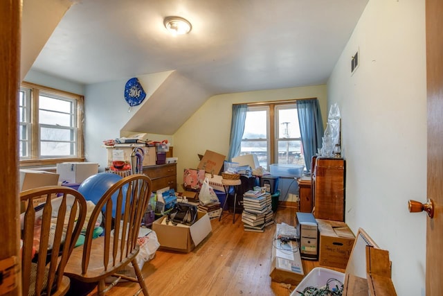 additional living space with lofted ceiling and light wood-type flooring