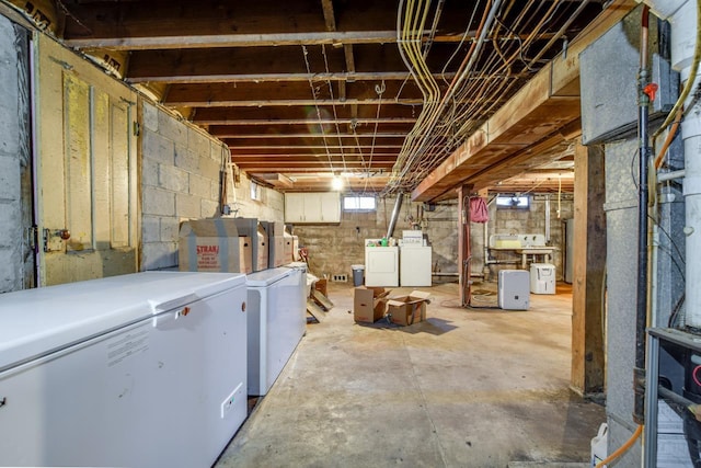 basement with independent washer and dryer and fridge