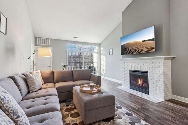 living room featuring a fireplace, high vaulted ceiling, and dark hardwood / wood-style floors