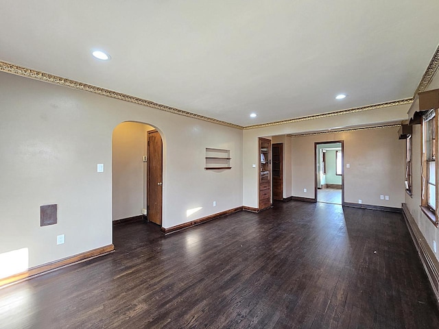 unfurnished room with dark wood-type flooring