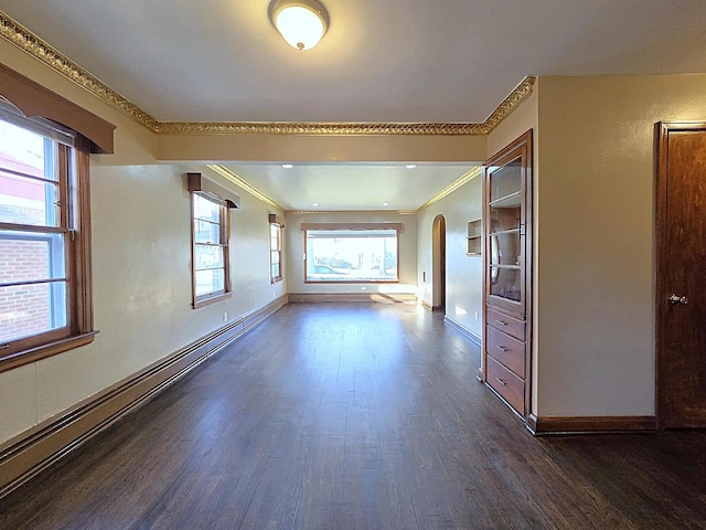 unfurnished room featuring dark hardwood / wood-style floors, ornamental molding, and baseboard heating